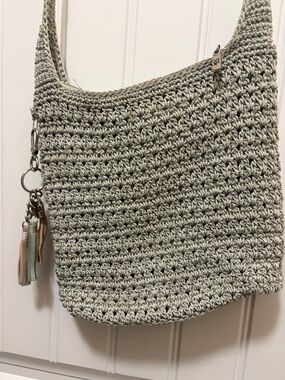 The Sak Crochet Shoulder Bag in Sage Green with Tassel Charm